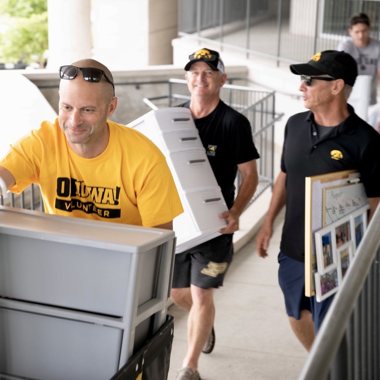 volunteer moving large cart