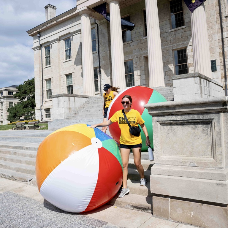 volunteer rolling giant beach ball