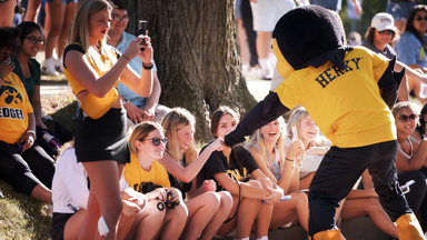 Herky mascot giving high fives